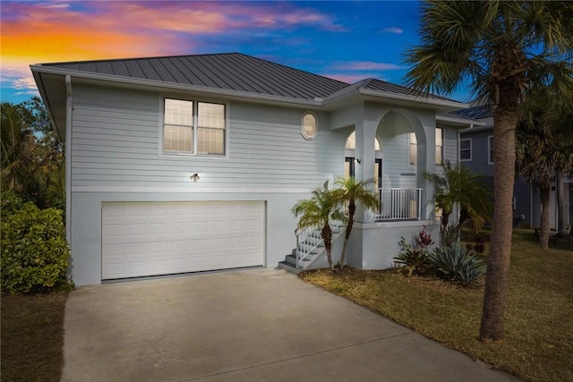 5440 95th St, Sebastian, FL 32958 - view of front of home featuring concrete driveway, a garage, a metal roof, and a standing seam roof