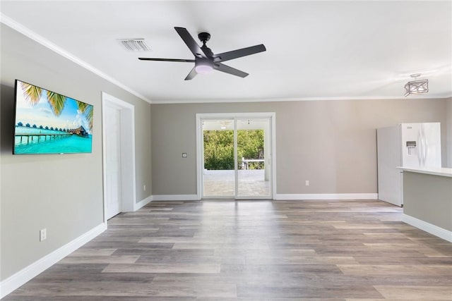 5440 95th St, Sebastian, FL 32958 - unfurnished living room with ornamental molding, a ceiling fan, and wood finished floors