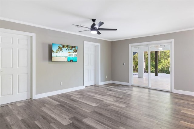 5440 95th St, Sebastian, FL 32958 - unfurnished bedroom featuring access to outside, crown molding, wood finished floors, and a ceiling fan