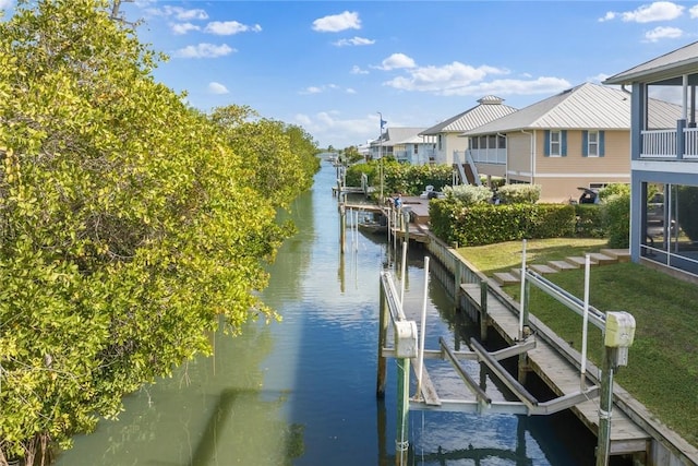5440 95th St, Sebastian, FL 32958 - dock area featuring boat lift, a water view, and a lawn