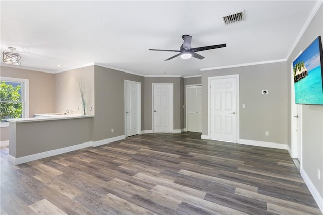 5440 95th St, Sebastian, FL 32958 - unfurnished living room with a ceiling fan, wood finished floors, and crown molding