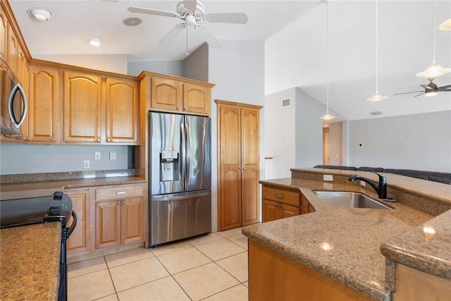 5440 95th St, Sebastian, FL 32958 - kitchen with stainless steel refrigerator with ice dispenser, ceiling fan, vaulted ceiling, stove, and light tile patterned flooring
