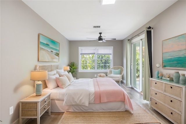 5440 95th St, Sebastian, FL 32958 - bedroom with access to exterior, wood finished floors, and ceiling fan