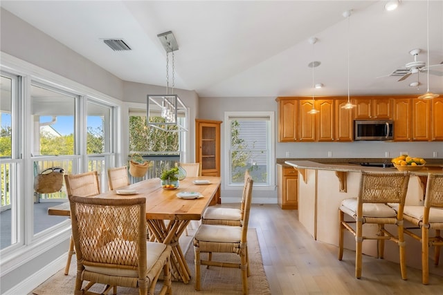 5440 95th St, Sebastian, FL 32958 - dining area featuring light wood-style flooring, vaulted ceiling, plenty of natural light, and ceiling fan