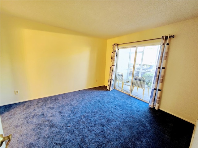 carpeted spare room featuring a textured ceiling