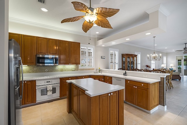 kitchen with kitchen peninsula, stainless steel appliances, light tile patterned flooring, and crown molding