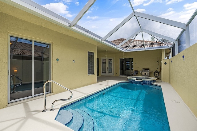 view of pool with an in ground hot tub, ceiling fan, a patio, a lanai, and area for grilling