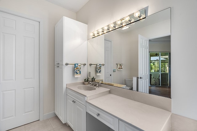 bathroom featuring toilet, vanity, and tile patterned flooring