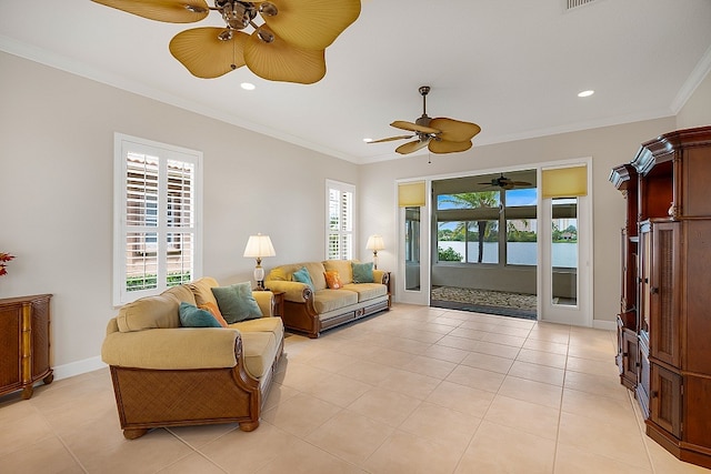 tiled living room with a water view, ceiling fan, and crown molding