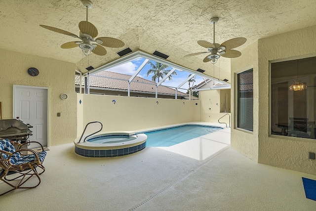 view of pool featuring ceiling fan, a skylight, and an in ground hot tub