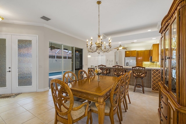 dining room with ceiling fan with notable chandelier, crown molding, light tile patterned floors, and french doors