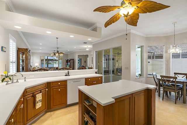 kitchen featuring hanging light fixtures, dishwashing machine, sink, and crown molding