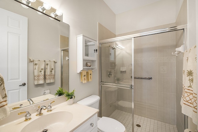 bathroom with toilet, vanity, and an enclosed shower