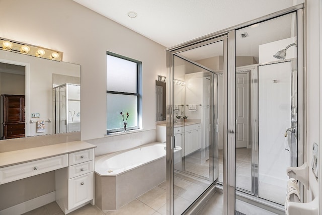 bathroom featuring plus walk in shower, vanity, and tile patterned floors