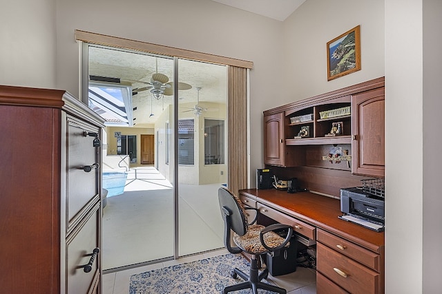 office space with ceiling fan and light tile patterned floors