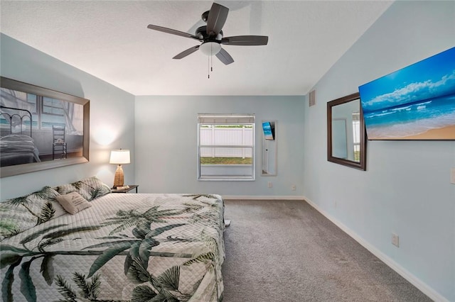 carpeted bedroom featuring ceiling fan and vaulted ceiling