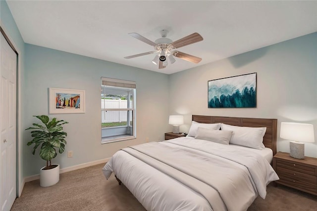 carpeted bedroom featuring a closet and ceiling fan