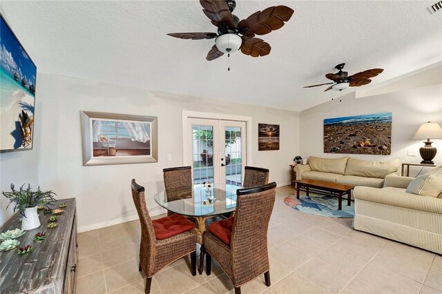 tiled dining area with a textured ceiling and lofted ceiling