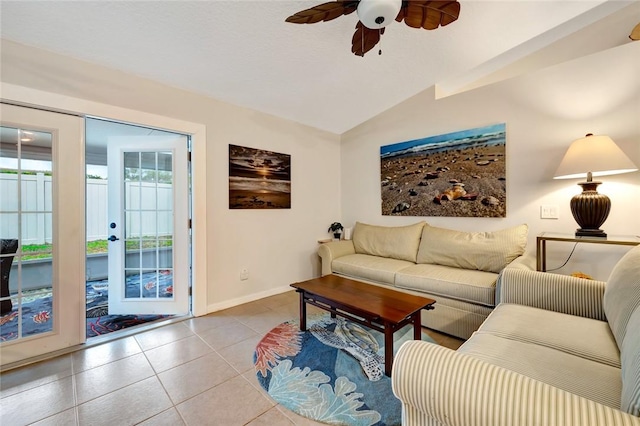 living room with lofted ceiling, ceiling fan, and light tile patterned flooring