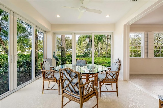 sunroom / solarium featuring ceiling fan