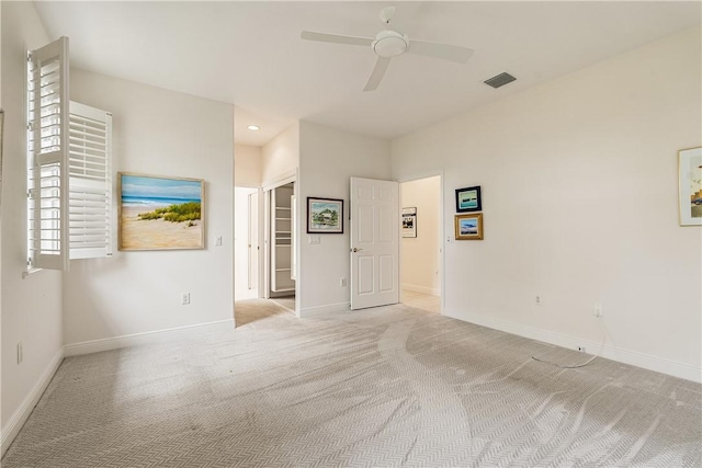 unfurnished room featuring ceiling fan and light colored carpet