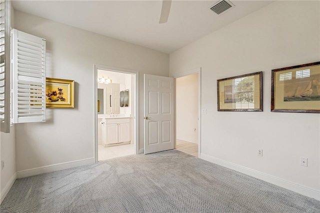 unfurnished bedroom with light carpet, sink, ceiling fan, and ensuite bathroom