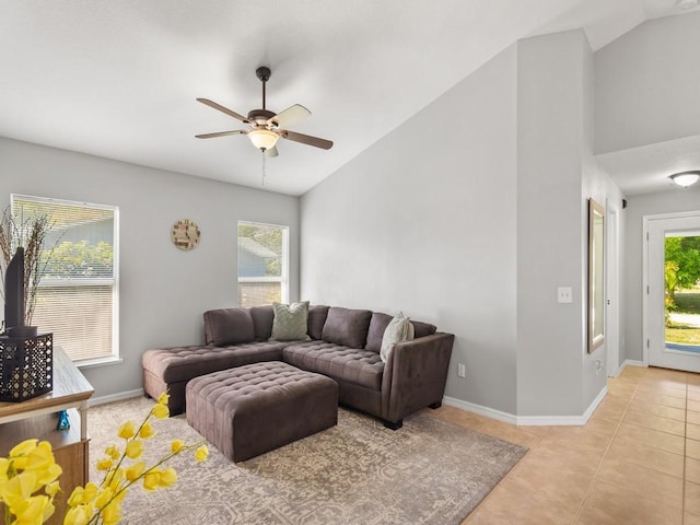 living area with lofted ceiling, plenty of natural light, and light tile patterned flooring