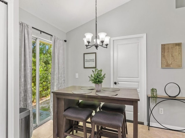 dining area featuring light tile patterned floors, a notable chandelier, and vaulted ceiling