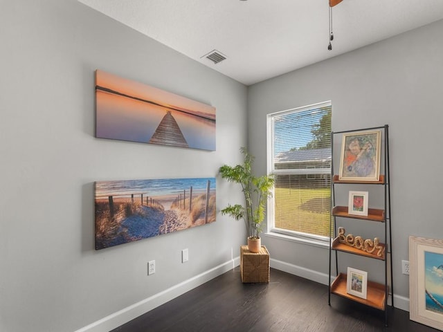 sitting room featuring visible vents, baseboards, and wood finished floors