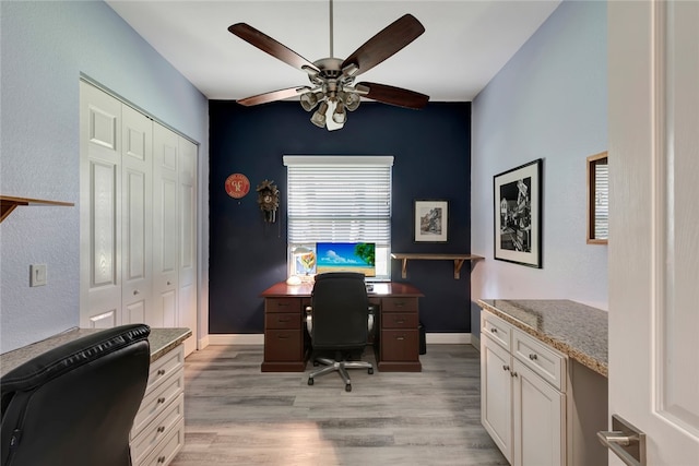 home office with ceiling fan and light hardwood / wood-style floors