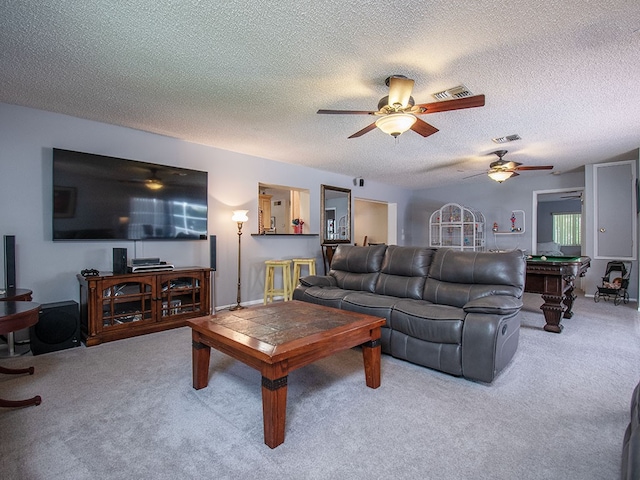 living area with carpet flooring, visible vents, and a ceiling fan