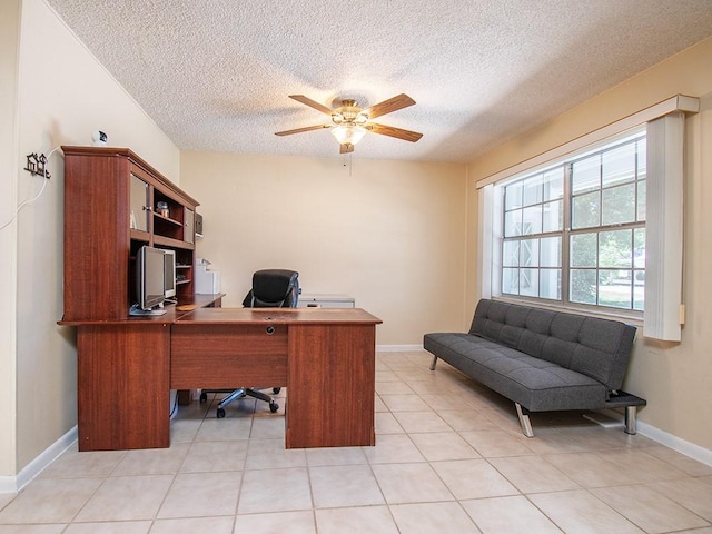 office area with a ceiling fan, light tile patterned floors, baseboards, and a textured ceiling