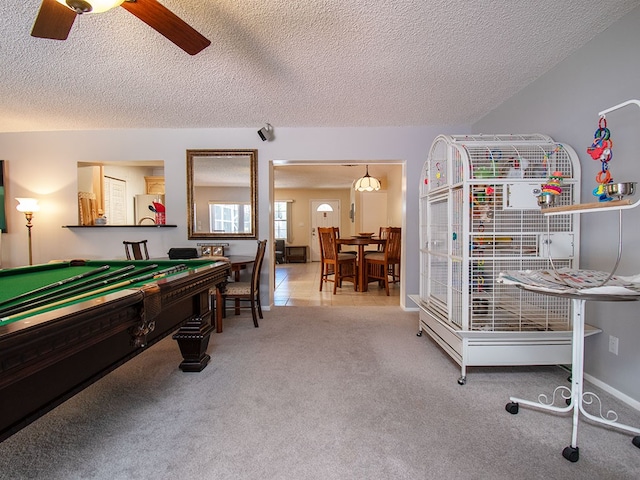 playroom with a textured ceiling, carpet, ceiling fan, billiards, and tile patterned flooring