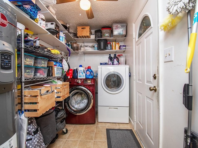 clothes washing area with separate washer and dryer, a textured ceiling, tile patterned floors, a ceiling fan, and laundry area