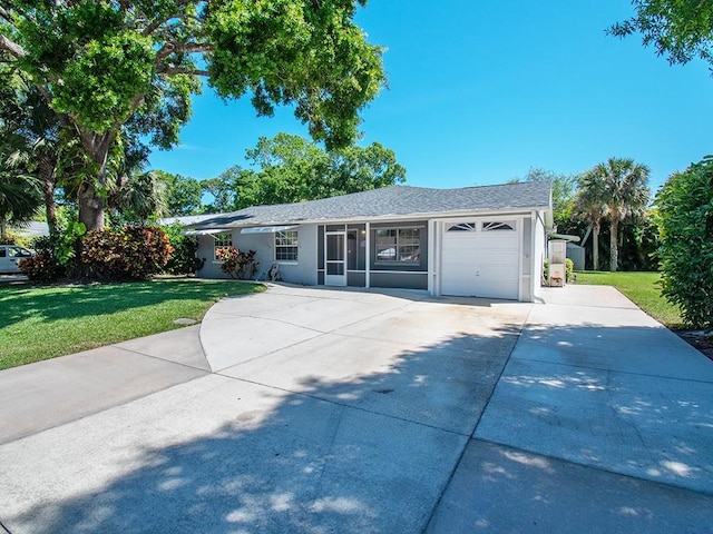 single story home featuring a front yard, an attached garage, stucco siding, and concrete driveway