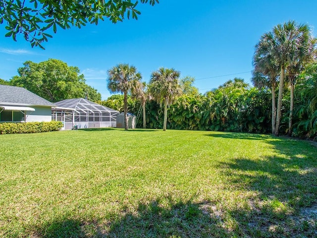 view of yard featuring glass enclosure