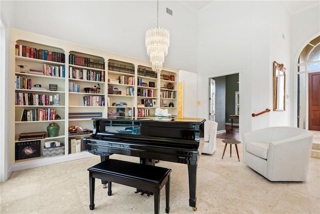 misc room featuring a high ceiling and a notable chandelier