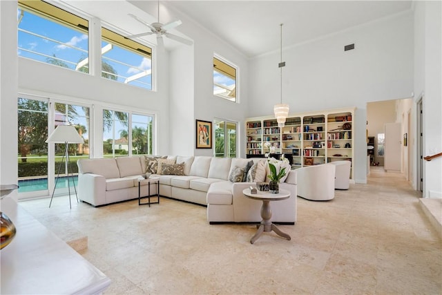 living room featuring a towering ceiling and ceiling fan