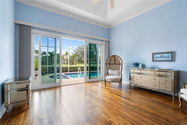 sitting room with crown molding, dark hardwood / wood-style floors, and ceiling fan