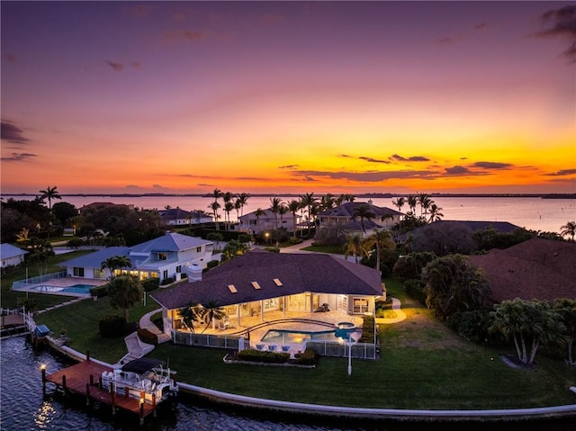 aerial view at dusk with a water view