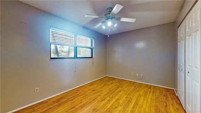 unfurnished bedroom with a closet, ceiling fan, and light wood-type flooring