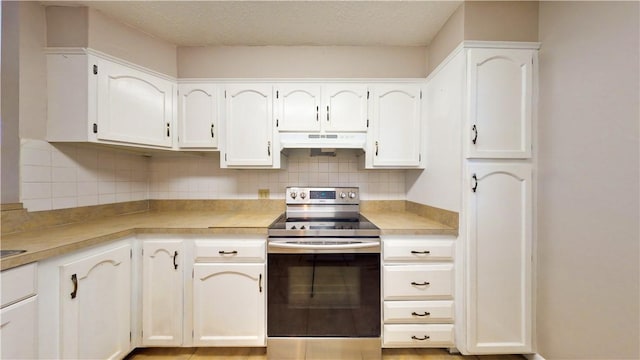 kitchen featuring white cabinetry, a textured ceiling, stainless steel electric stove, and tasteful backsplash