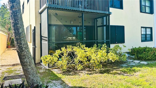 view of side of home with a sunroom