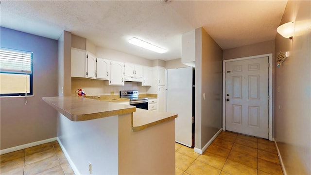 kitchen with light tile patterned floors, white cabinetry, electric range, kitchen peninsula, and white fridge