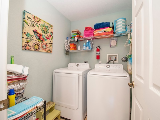 laundry room with washing machine and dryer and a textured ceiling