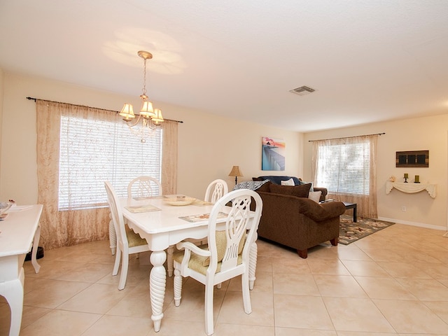 tiled dining area featuring a notable chandelier