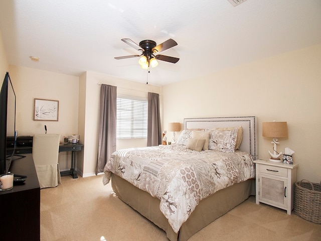 bedroom featuring light colored carpet and ceiling fan