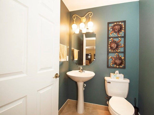 bathroom featuring toilet and tile patterned flooring