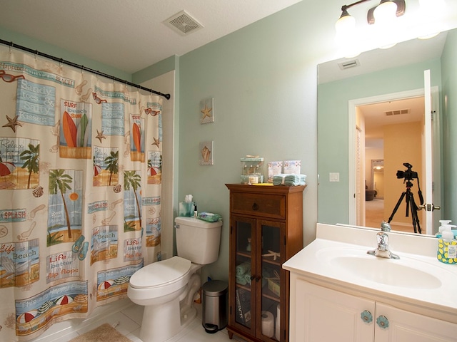 full bathroom with vanity, tile patterned floors, toilet, and shower / tub combo