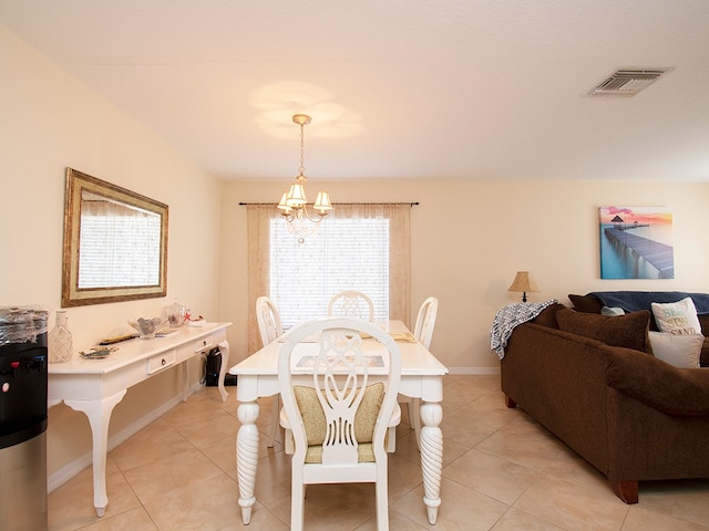 dining area featuring a chandelier and light tile patterned floors